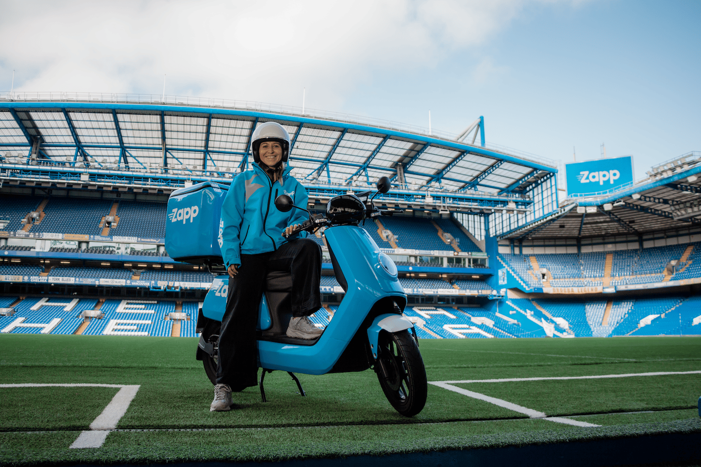 Zapp delivery driver sits on moped in Stamford Bridge