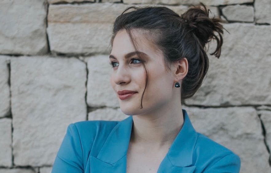 An image of Konstantina Psoma, cofounder and CEO of Kaedim, one of Sifted's under the radar Greek startups to watch. She's wearing a blue blazer, and has her, which is brown, hair tied up