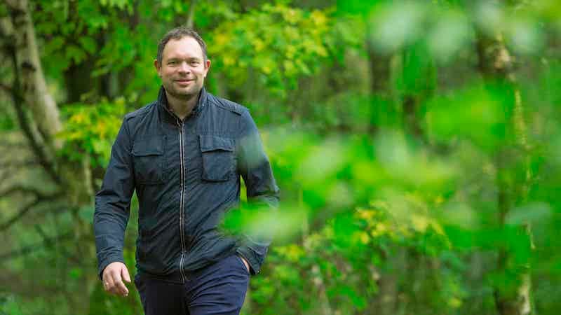 A picture of Jakob Krogsgaard, CEO of Everfuel, walking in the woods.