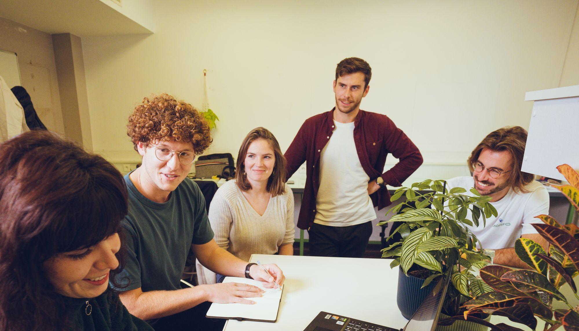 A photo of the Morfo team sat around a table