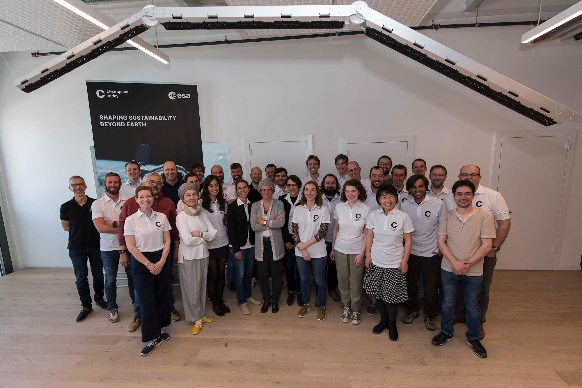 The ClearSpace team under a structure prototype of the capture system robotic arm_ full size