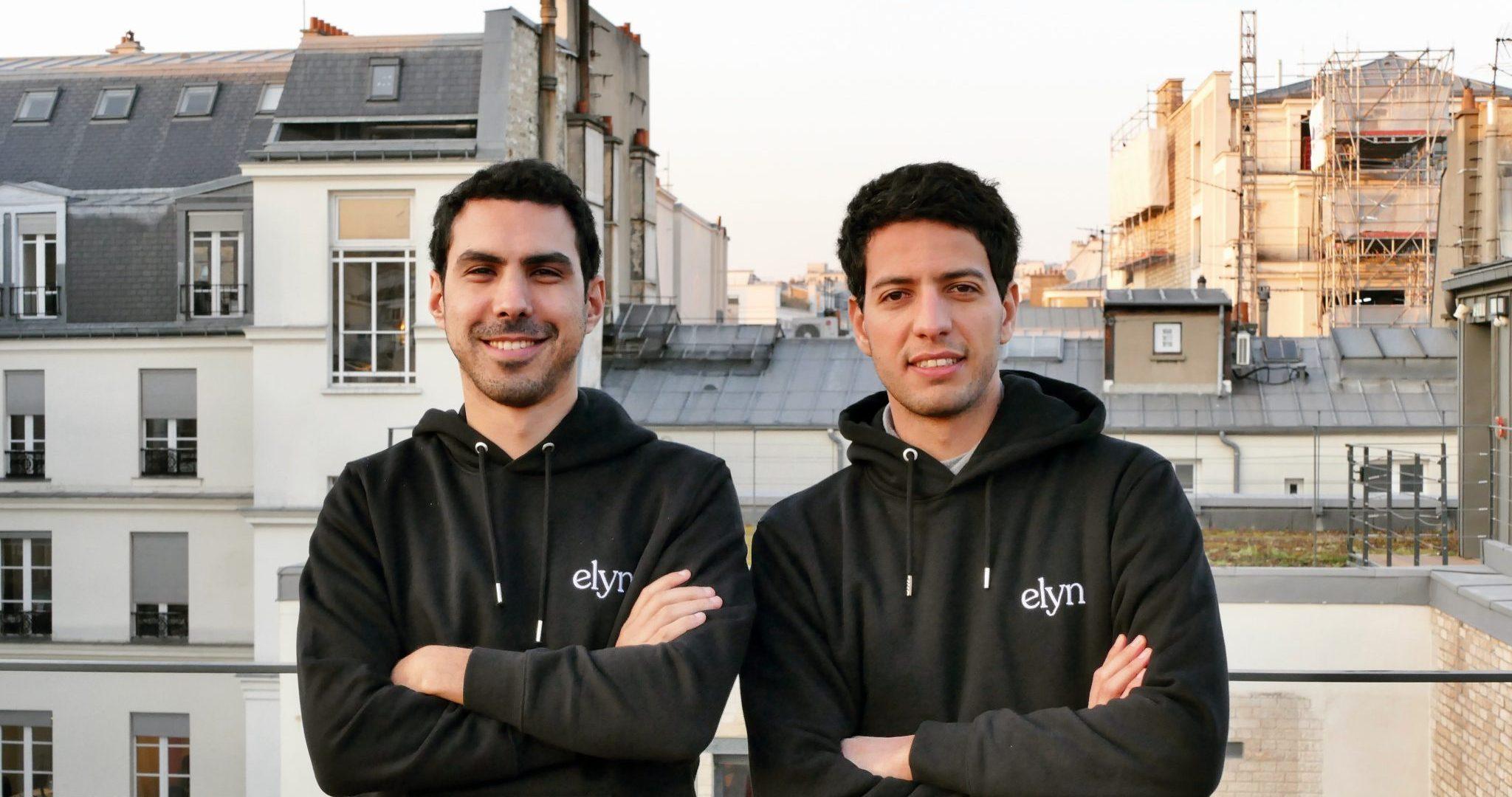 A photo of the Elyn founders stood next to each other with their arms crossed.
