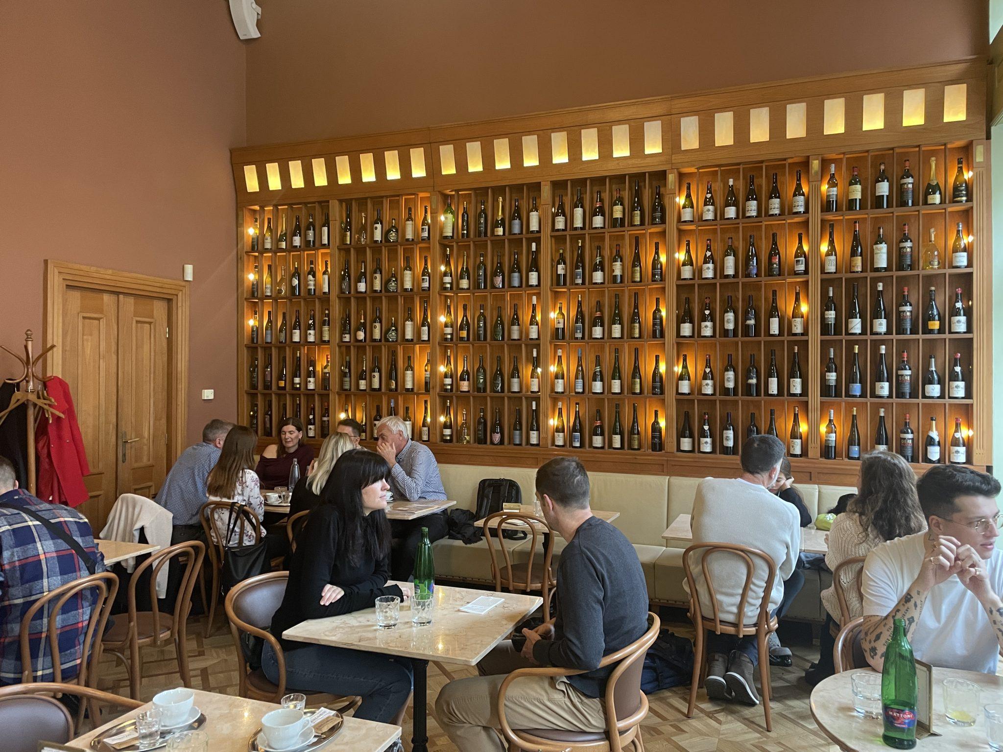 People sat down eating at the Cafe Savoy.
