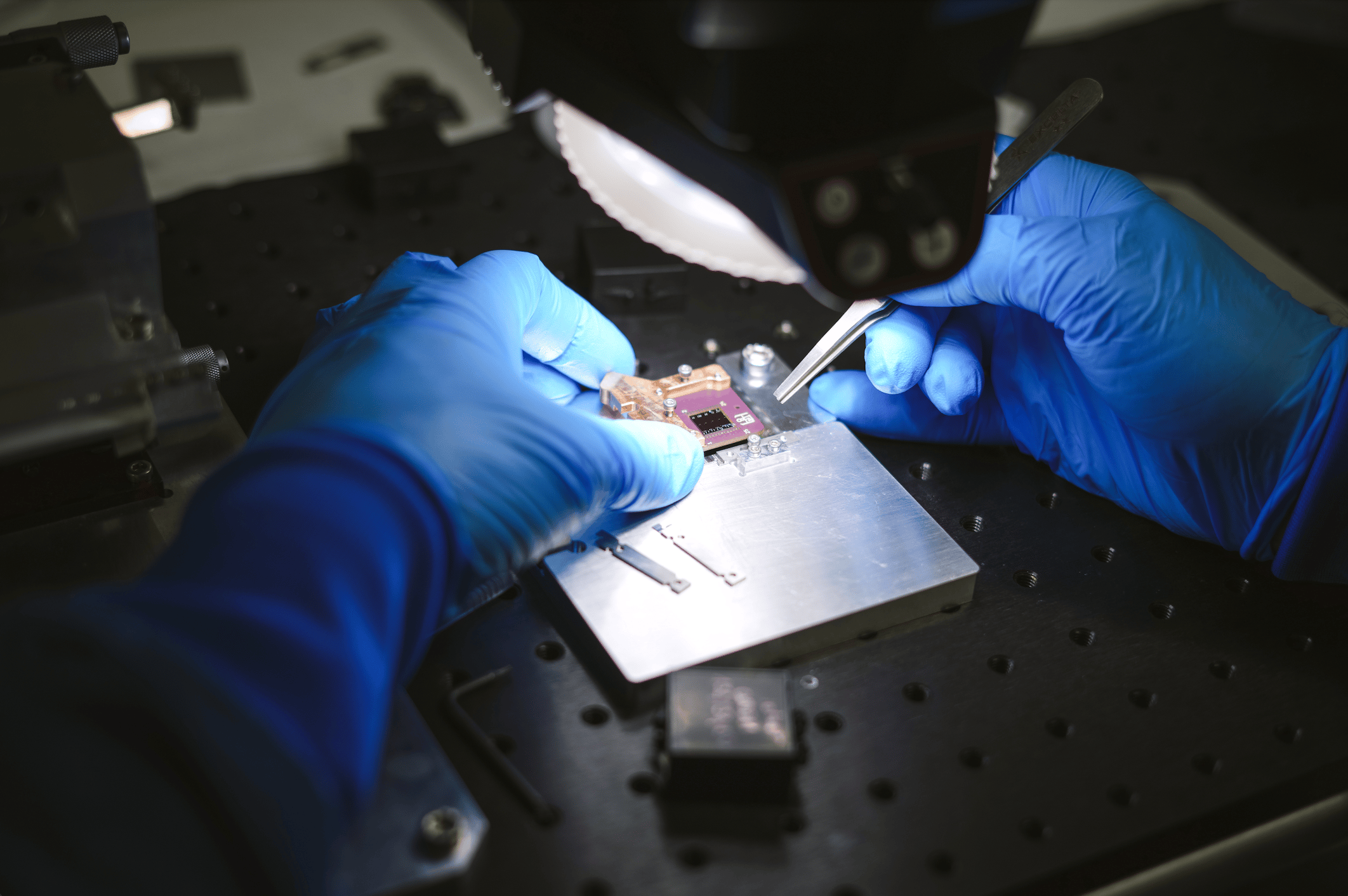 Human hands manipulating one of C12's quantum chips. Credit: Sophie Derrien