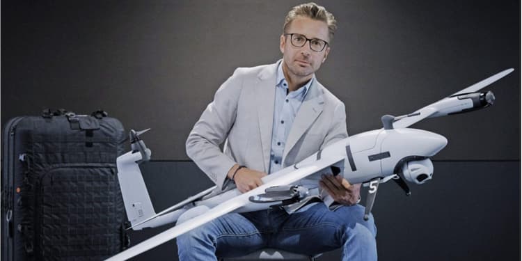Quantum Systems and Stark founder Florian Seibel sits holding a drone.