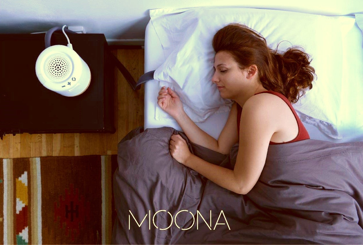 Image of woman lying asleep in bed on a Moona cooling pillow – the pillow created to relieve menopause issues