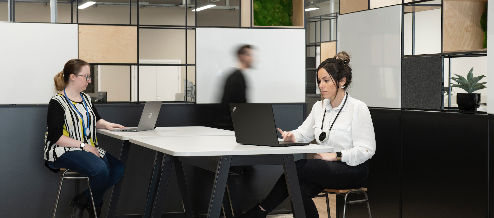 Two women in the office wearing Tharsus Bump wearables