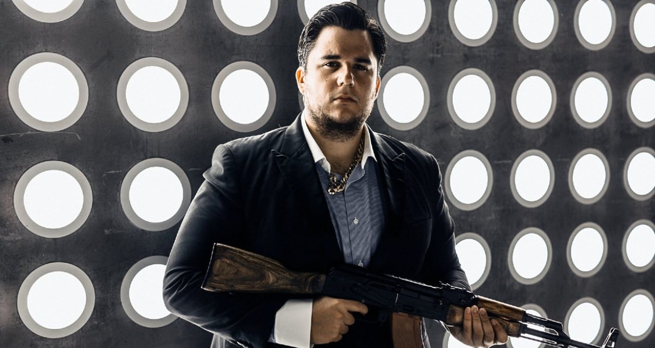 Photo of The chief executive of Escobar Inc, Olof Gustafsson, posing with a kalashnikov during a visit to Russia. Photo: Twitter.