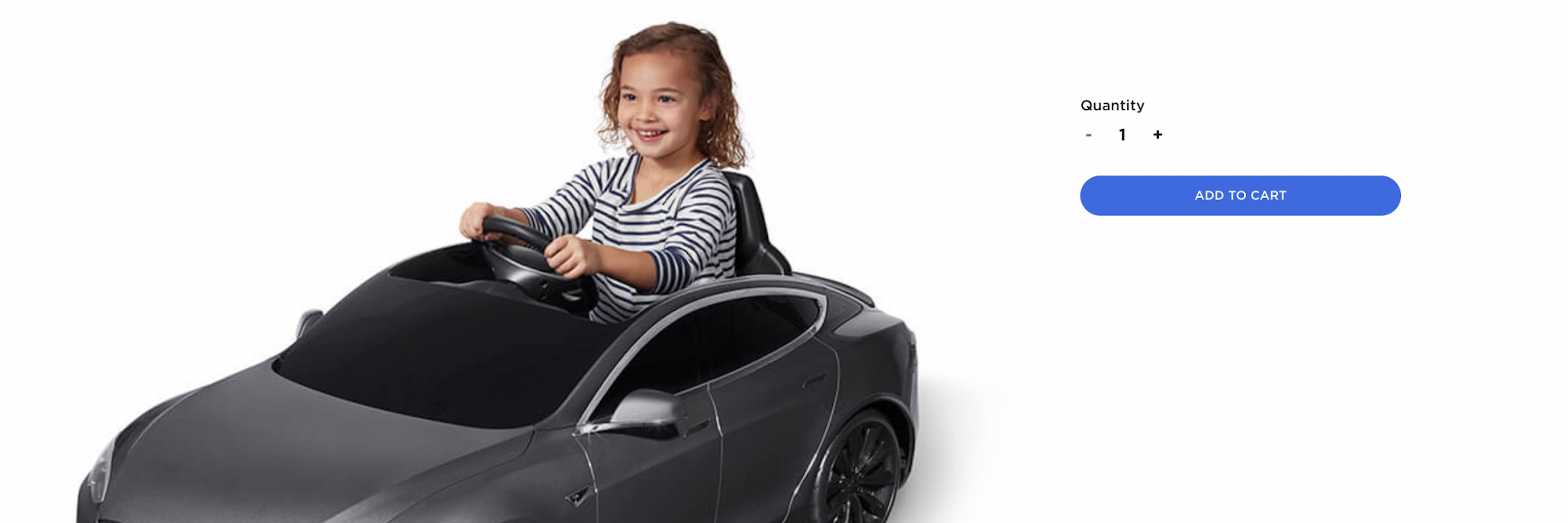 A screenshot from the Tesla e-commerce shop showing a child in a toy car