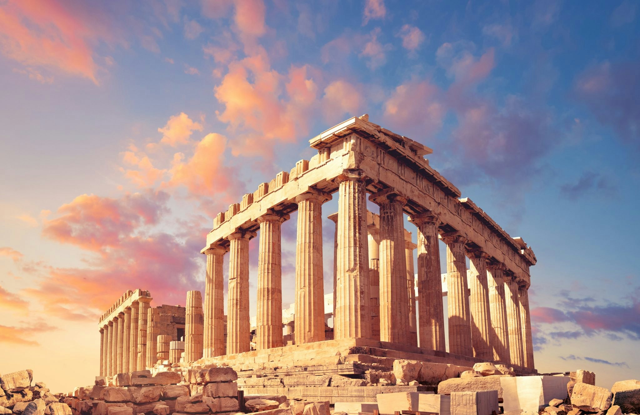 Parthenon temple on a sunset with pink and purple clouds. Acropolis in Athens, Greece