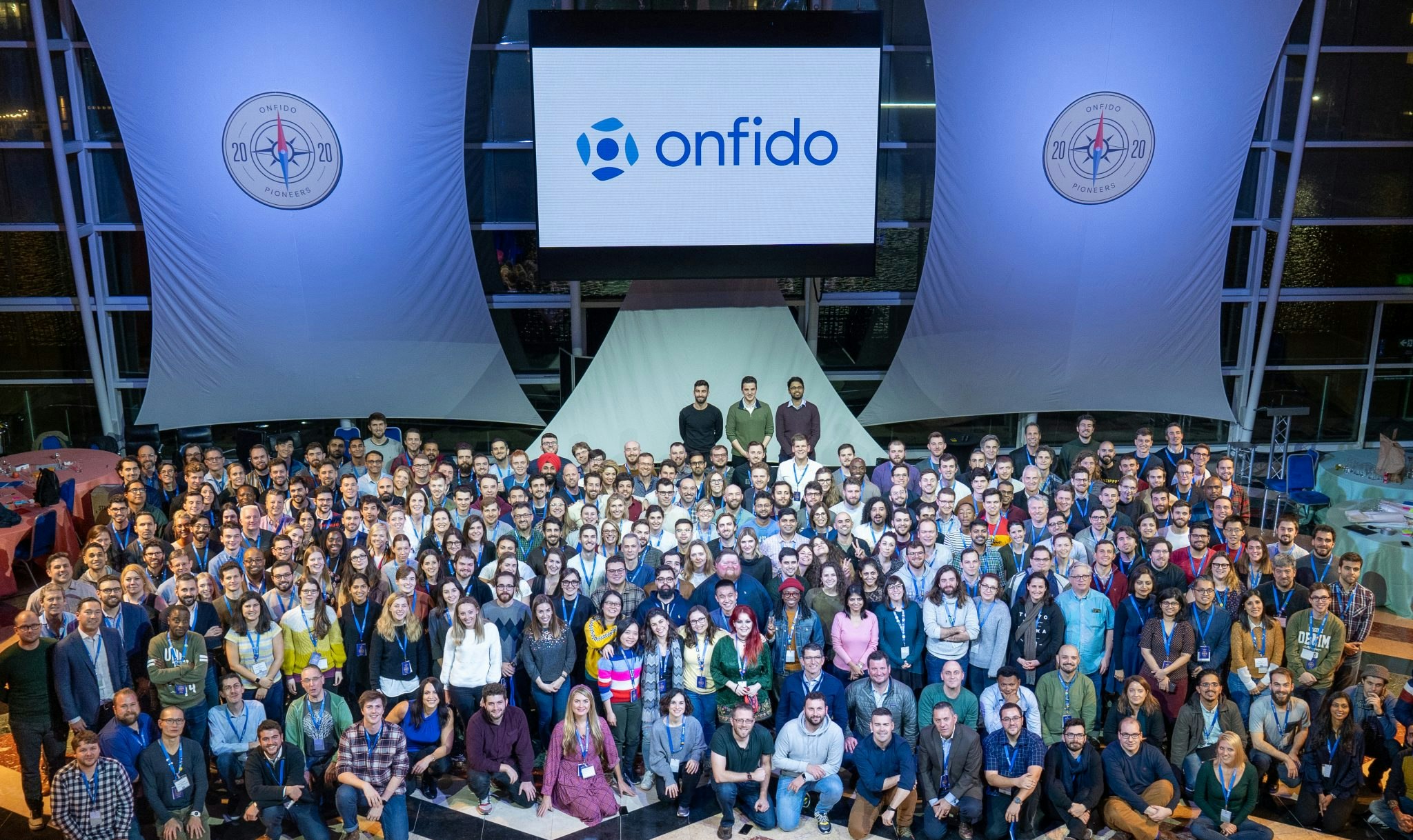 A group photo of Onfido employees at a conference