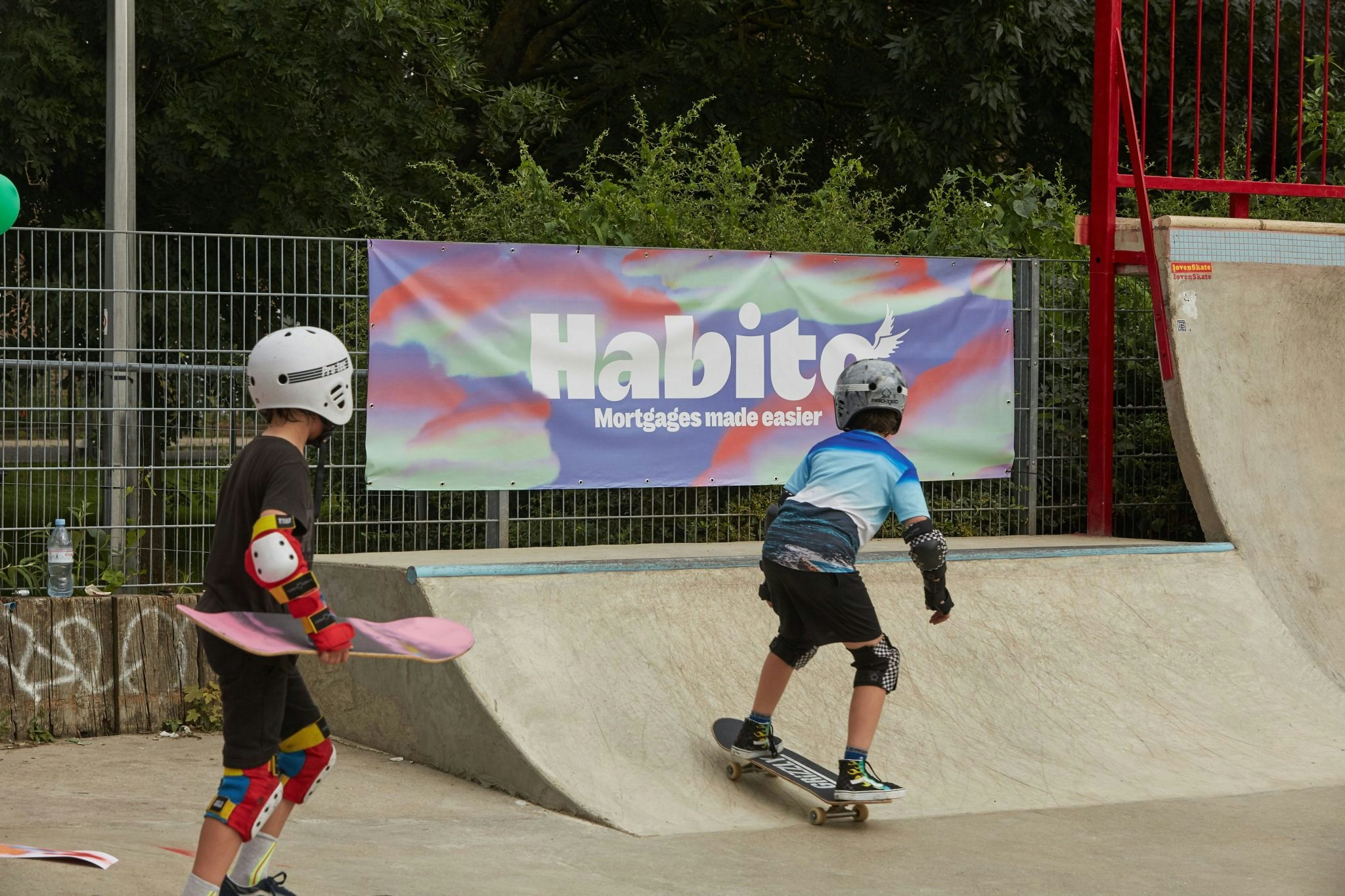 Children on skatepark with Habito branding in the background.