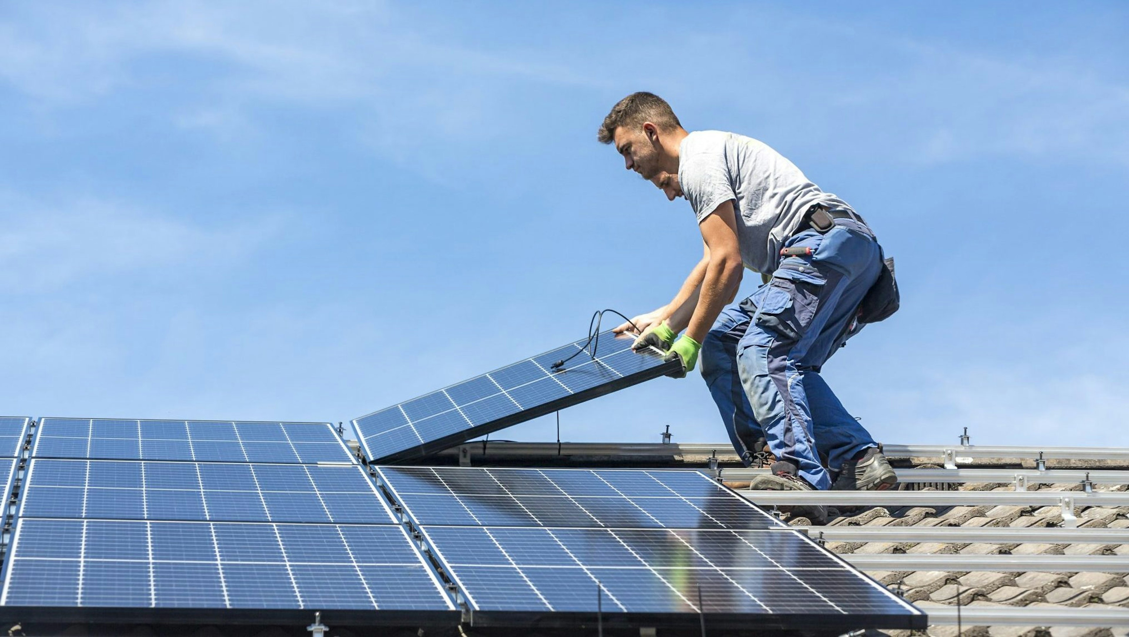 Someone carrying out Enpal's solar installation on a roof.