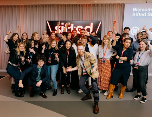 Sifted team with the Sifted logo behind them