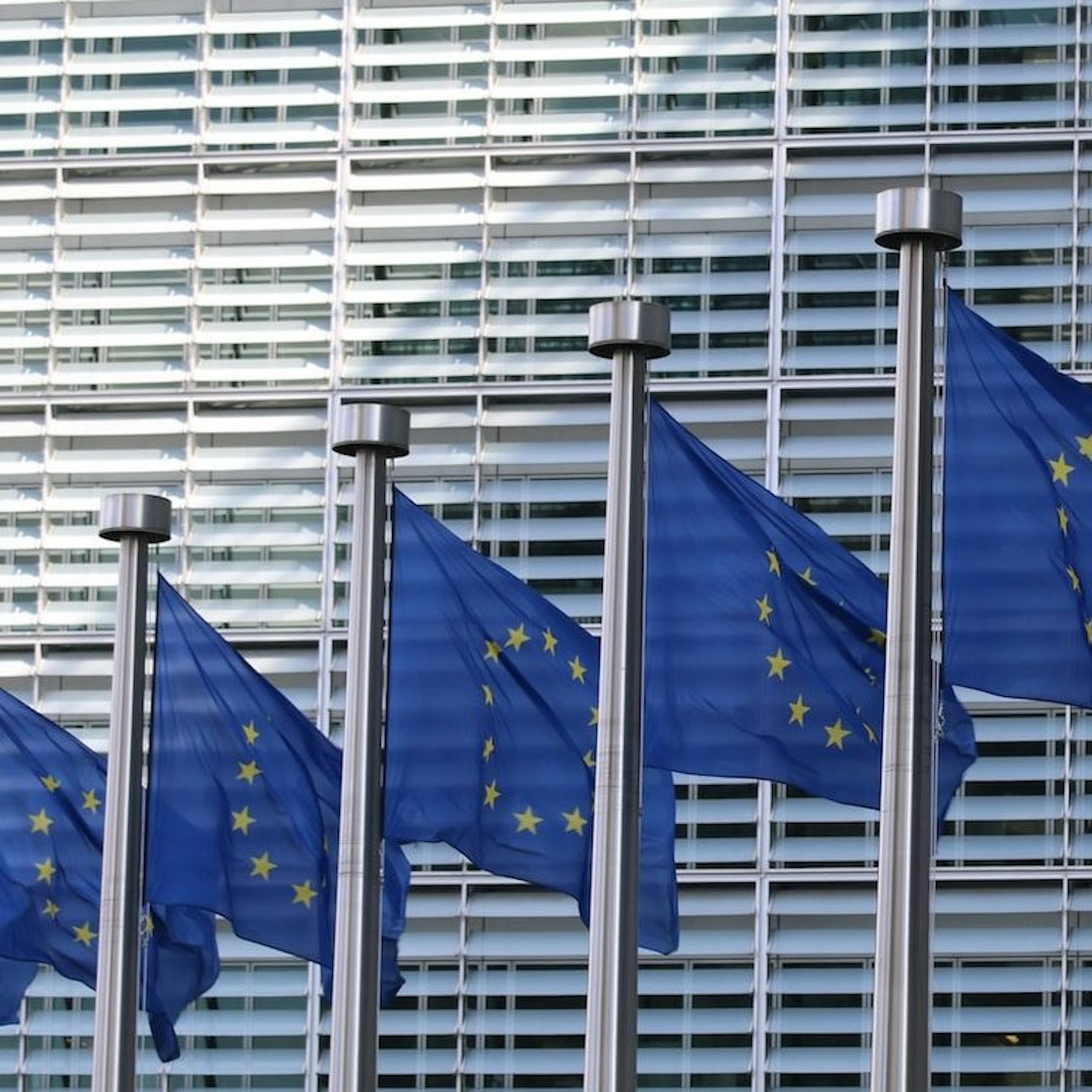 Image of EU flags outside the European Commission building in Brussels