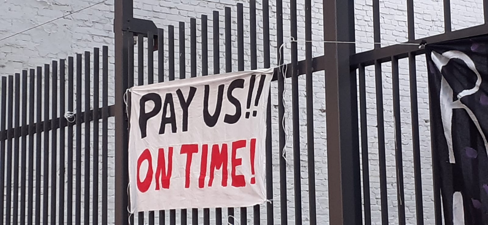 A banner from a Street Fleet protest in Berlins that reads &quot;Pay us!! On Time!&quot;