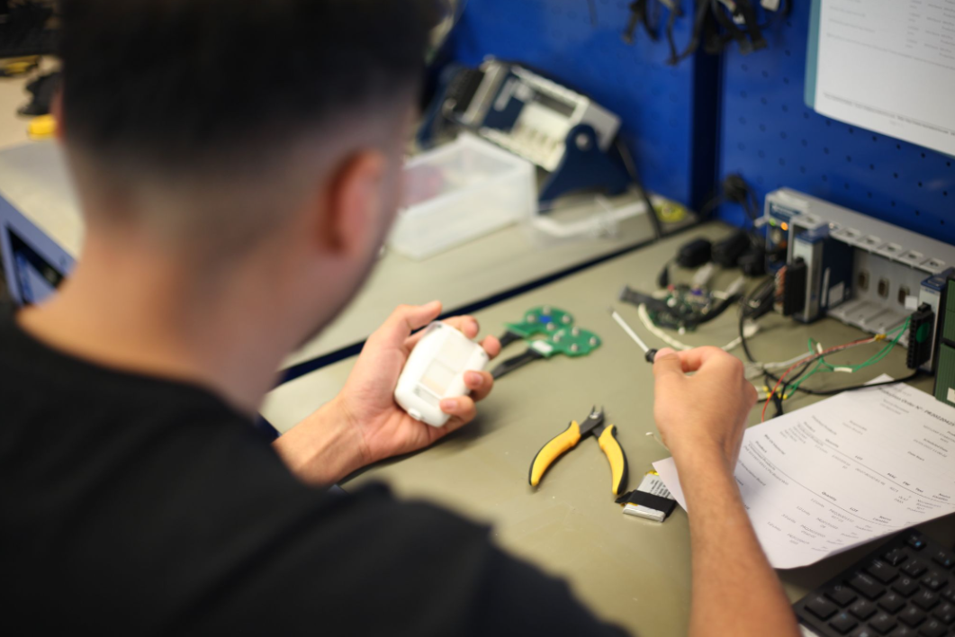 An image of a Starlab researcher working on circuitry for a Starstim headcap