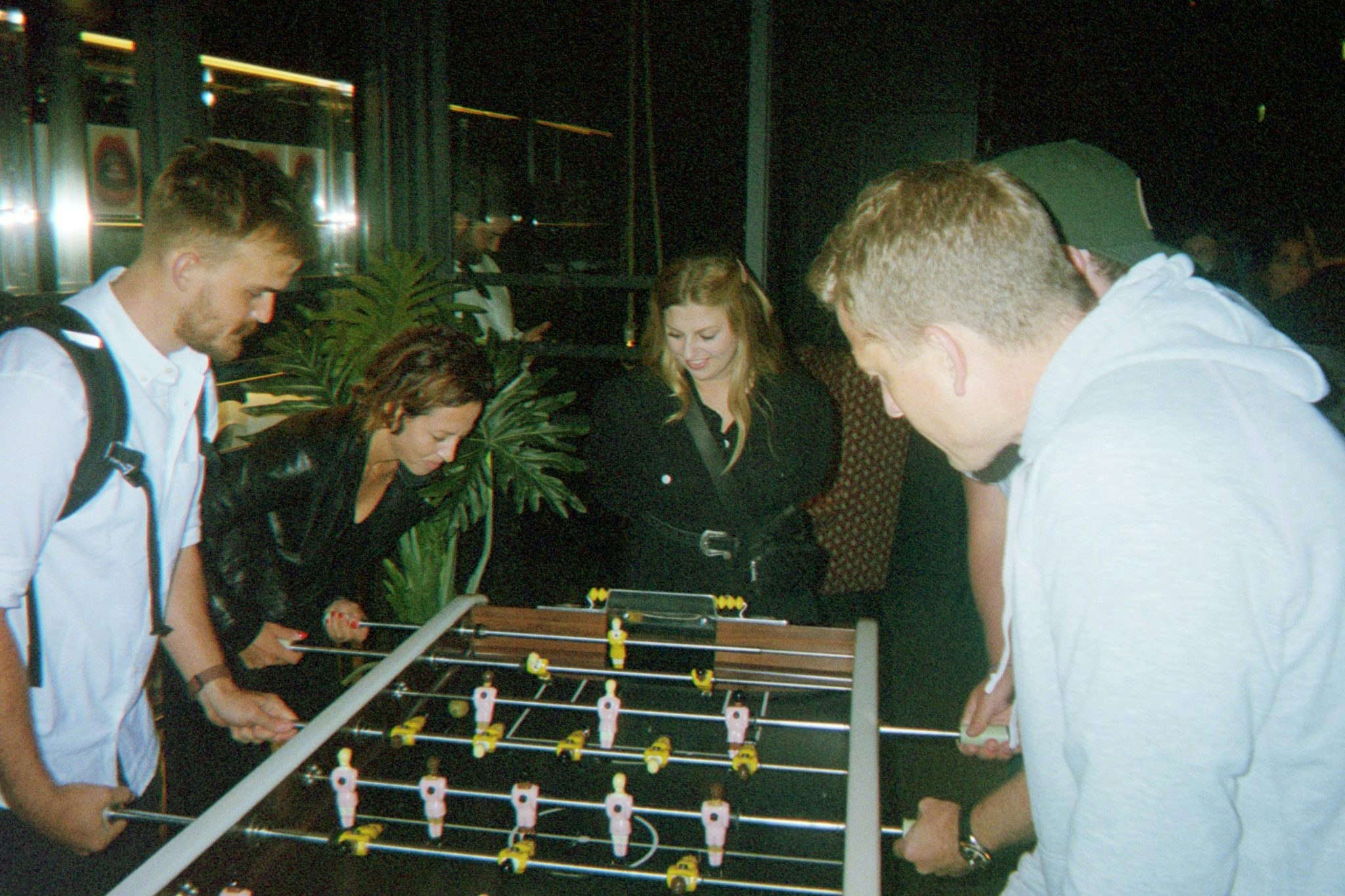 A photograph of Bounce staff playing table football at night