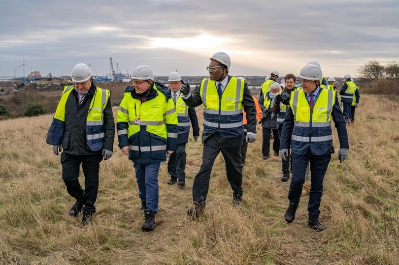 An image of former business secretary Kwasi Kwarteng with the Britishvolt team walking through a field. Photo: Bri