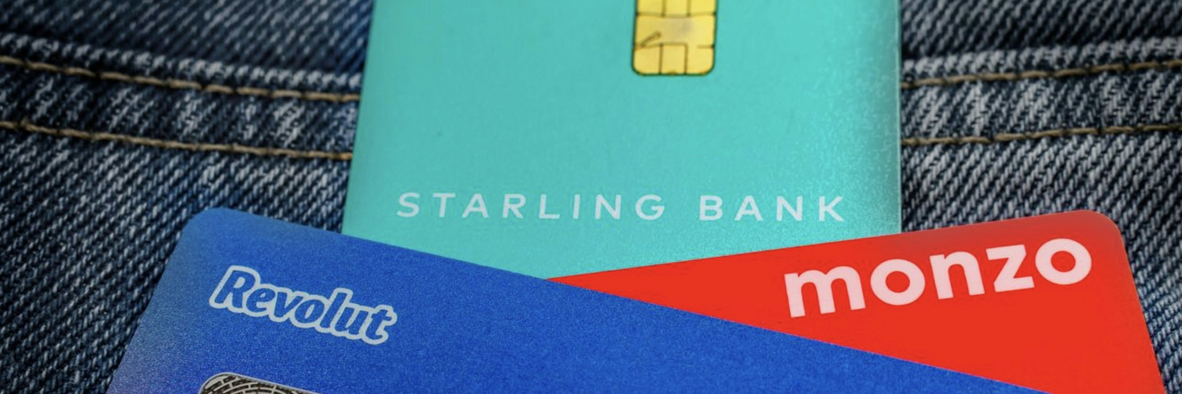 An image of starling, monzo and revolut cards in someone's pocket