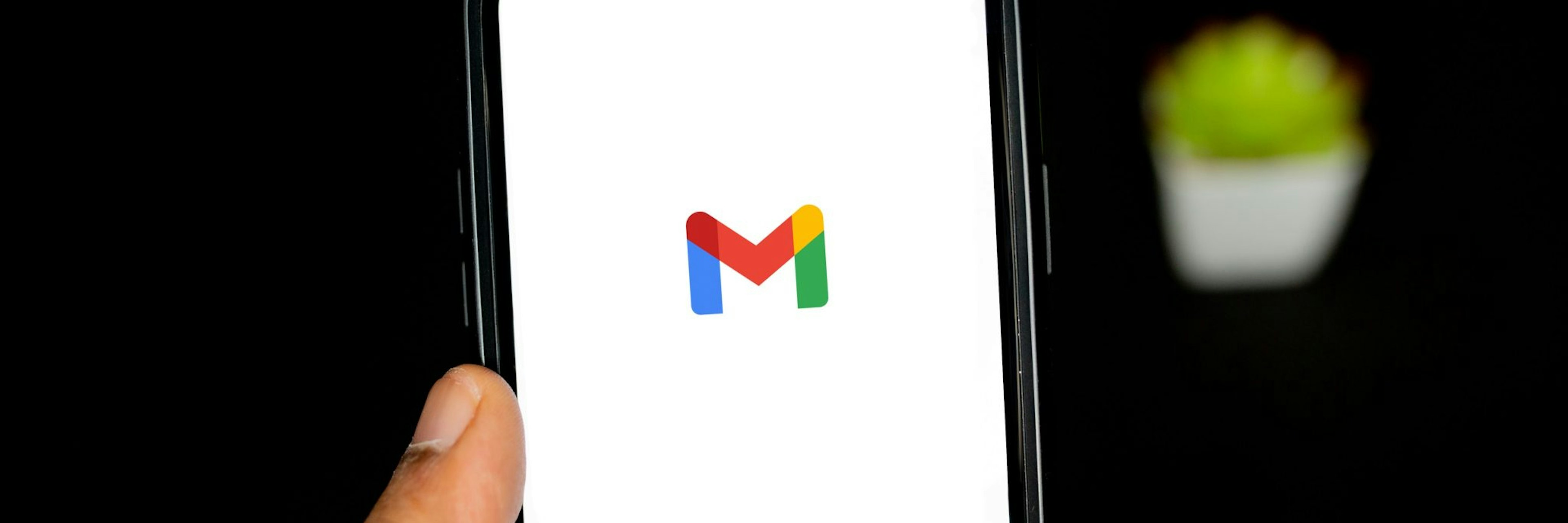 A mobile phone with the gmail logo on the screen