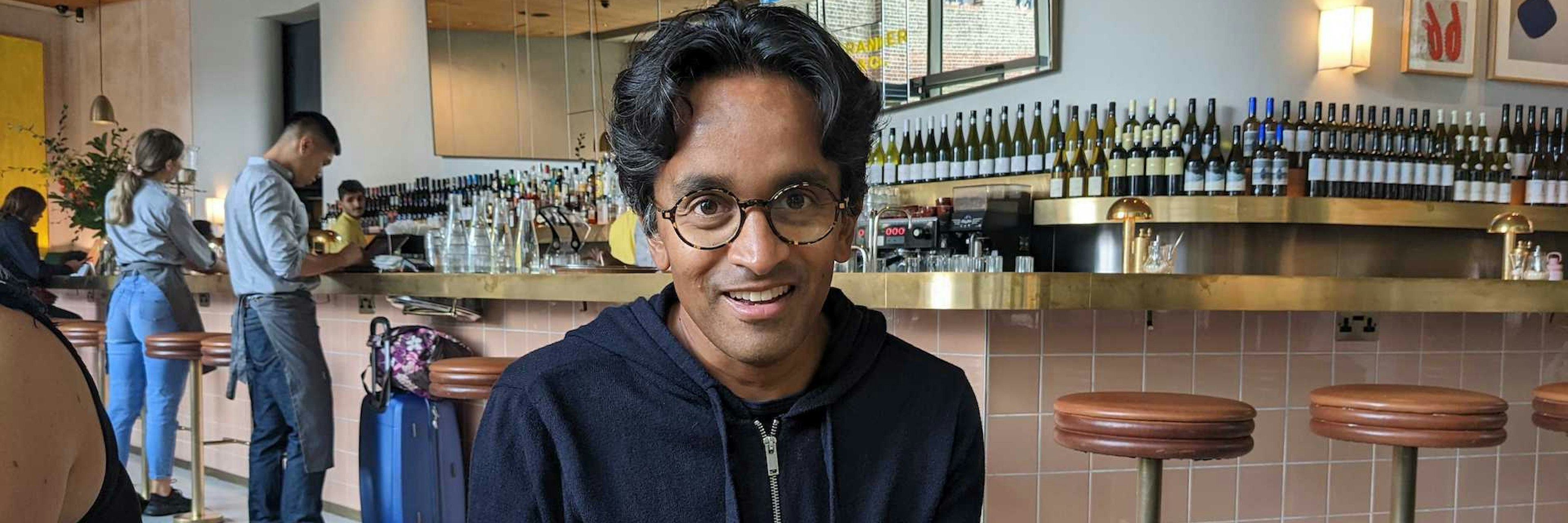 Suranga Chandratillake, partner at Balderton, sitting with a plate of scrambled eggs at brunch with Sifted