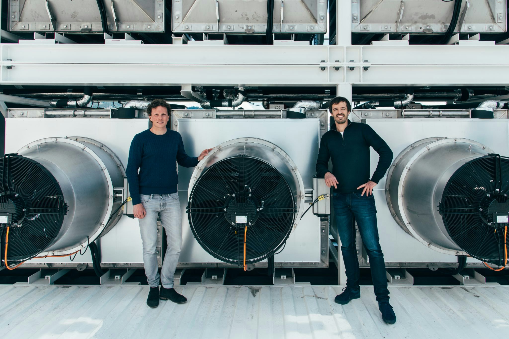 Climeworks founders C. Gebald and J. Wurzbacher in front of Climeworks plant in Switzerland.