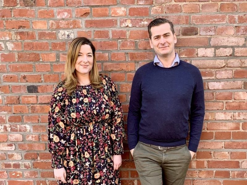 Sophie and Philippe Frères, founders of LiSA, standing against a brick wall