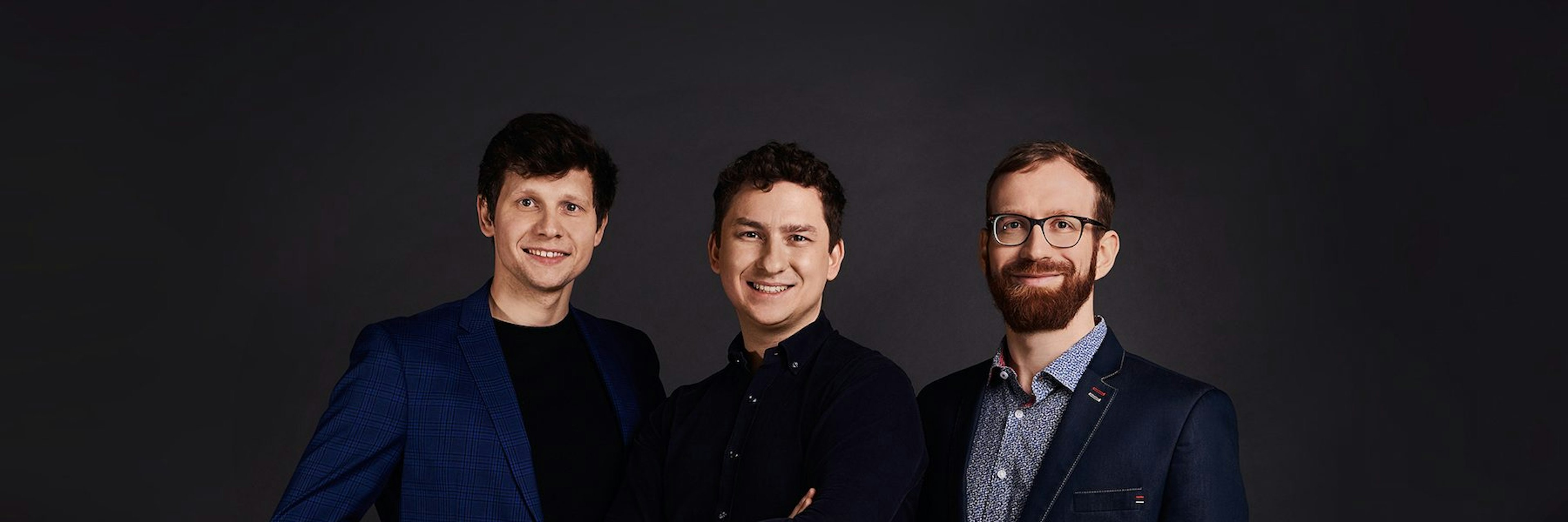 The three male founders of Plenti standing in a row on a dark background