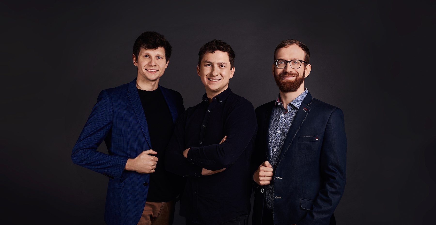 The three male founders of Plenti standing in a row on a dark background