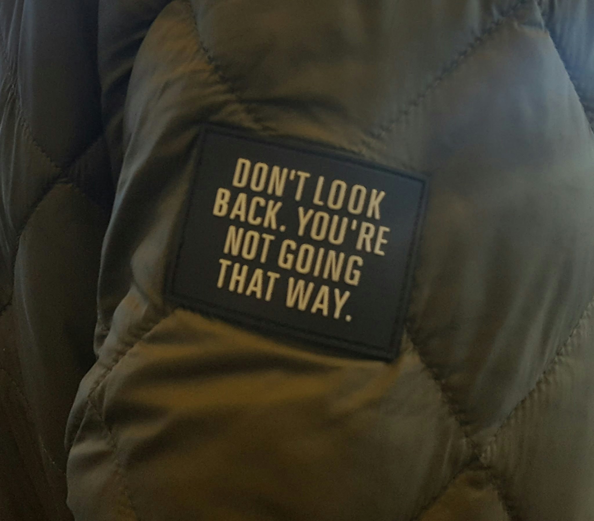 “I took the attached picture years ago at an airport (a man was wearing a jacket with a patch). It helps me keep moving forward in my own creative journey and in my career. It could help others who were laid off stay positive and focus on what's ahead.”