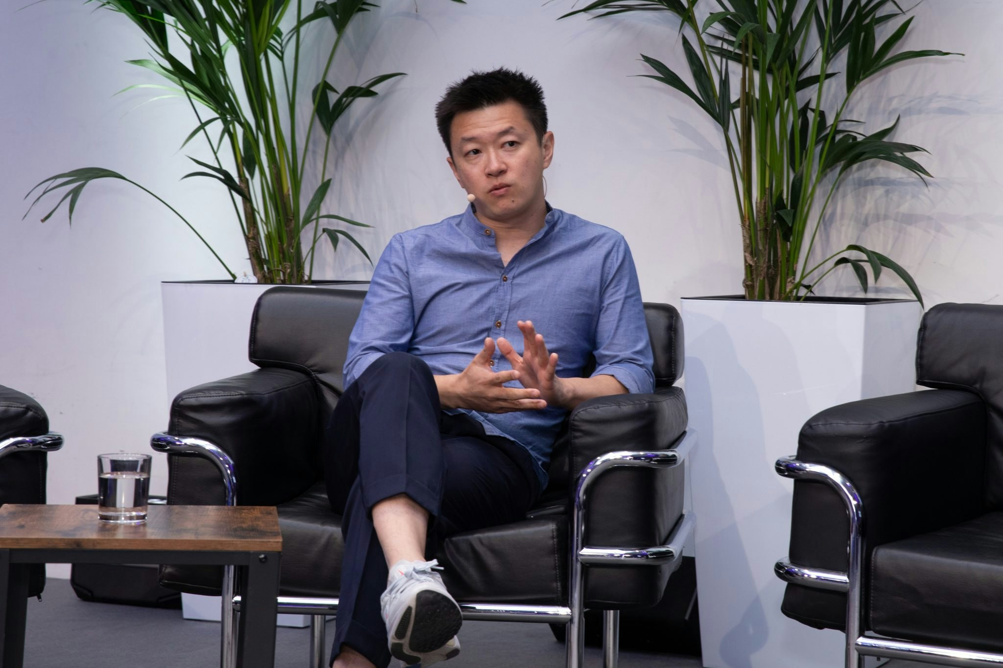 Tao Tao sitting in an armchair on a conference stage