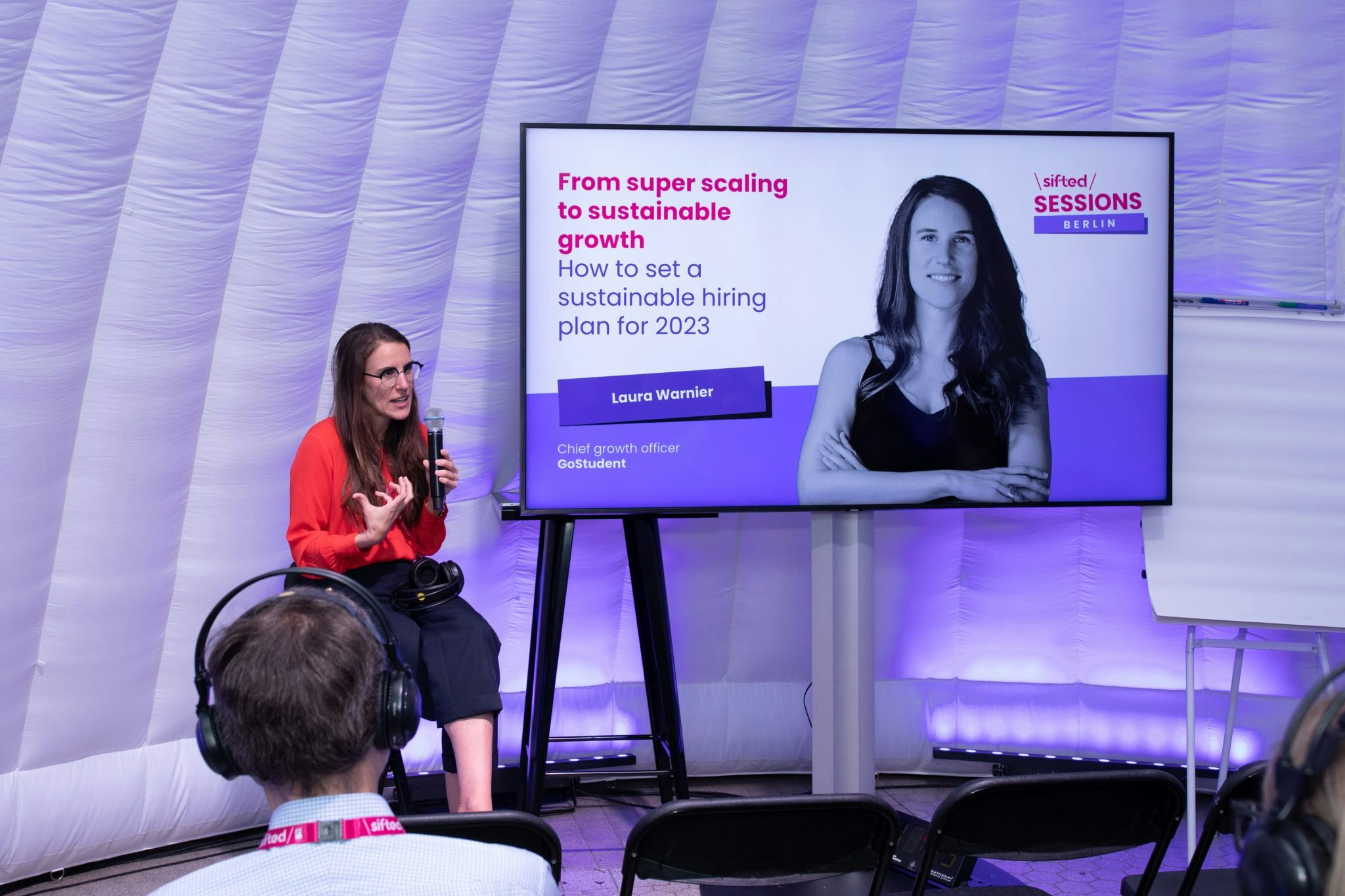 Laura Warnier, chief growth officer of GoStudent, sharing strategies for structuring teams in the “silent disco workshop igloo”