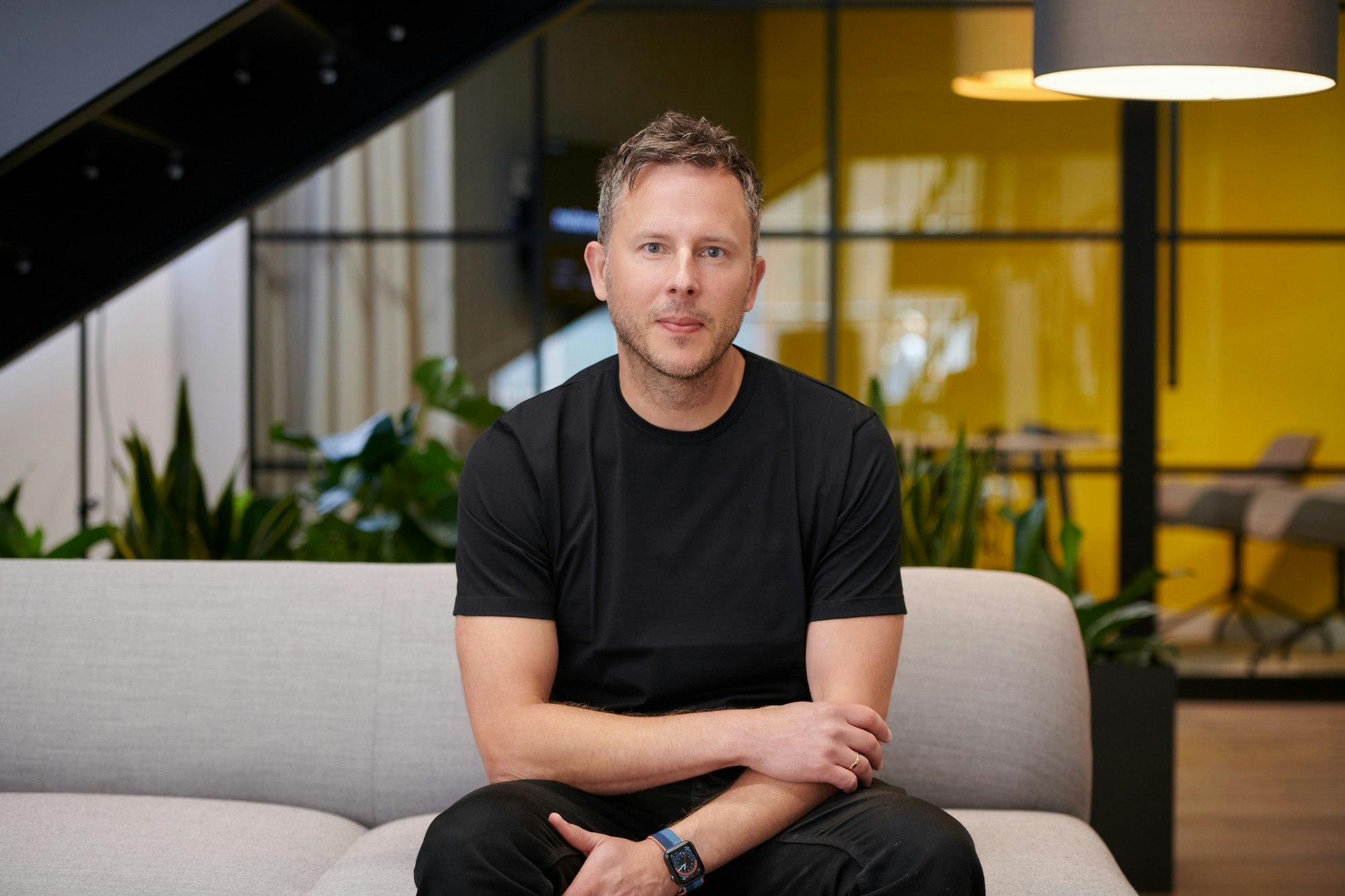 Corporate shot of Tom Leathes, CEO and cofounder of Motorway, sitting on a sofa