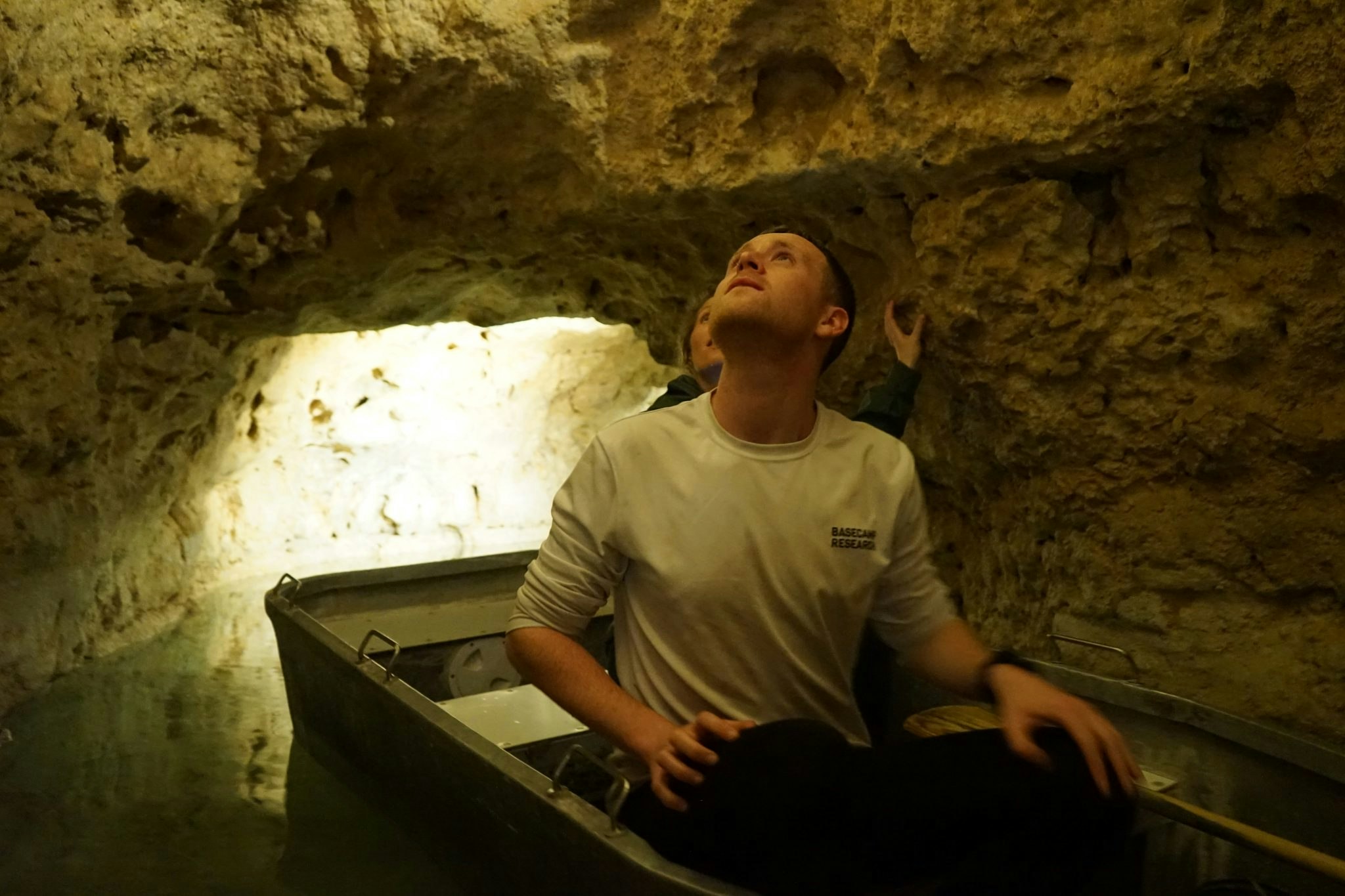 Basecamp's Ineke Knot and Marlon Clark in a boat inside a cave lake in Hungary.