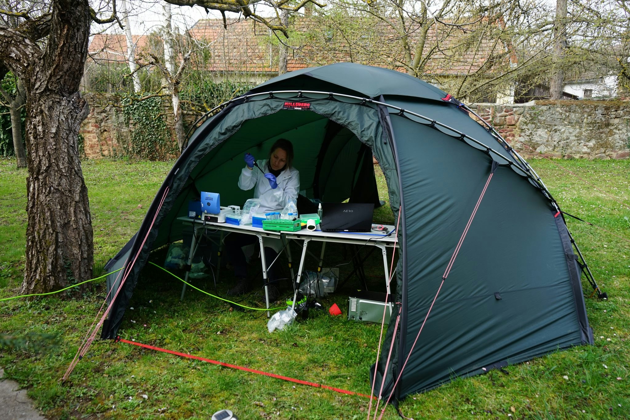 Basecamp's Ineke Knot conducting sampling tests in a tent.