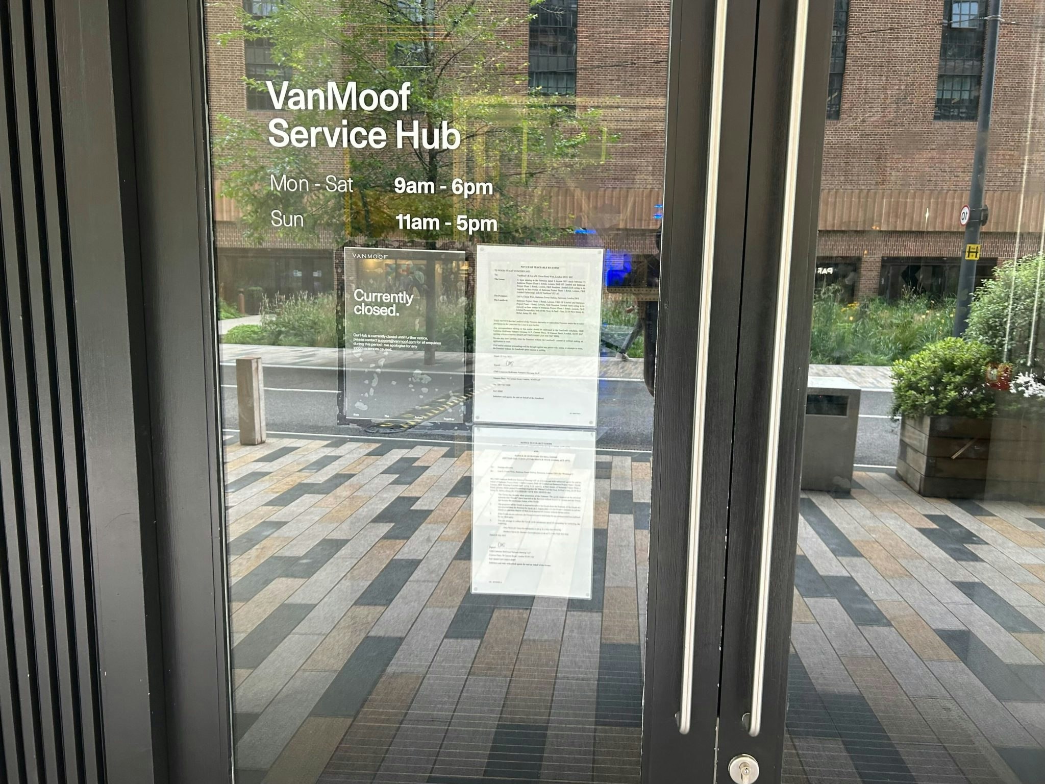 The front doors to the VanMoof Battersea shop, London, with a sign saying the store is closed.