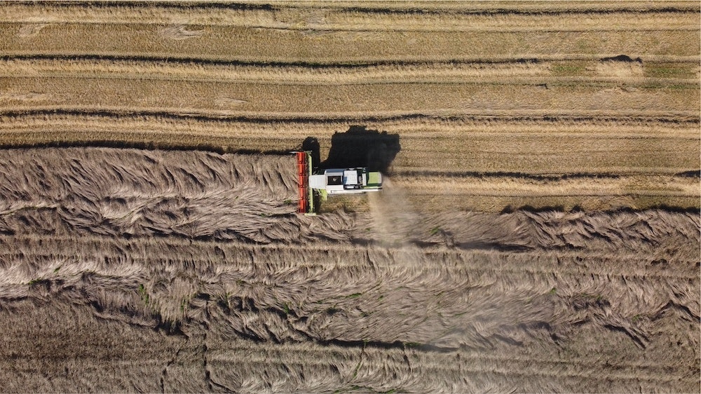 A farming vehicle ploughing a field, getting it ready for regenerative agriculture. 