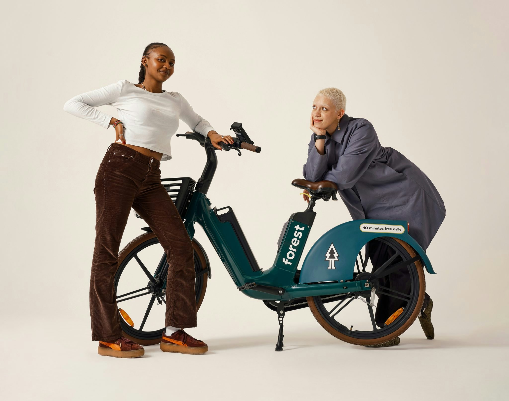 Two people posing next to a Forest e-bike.