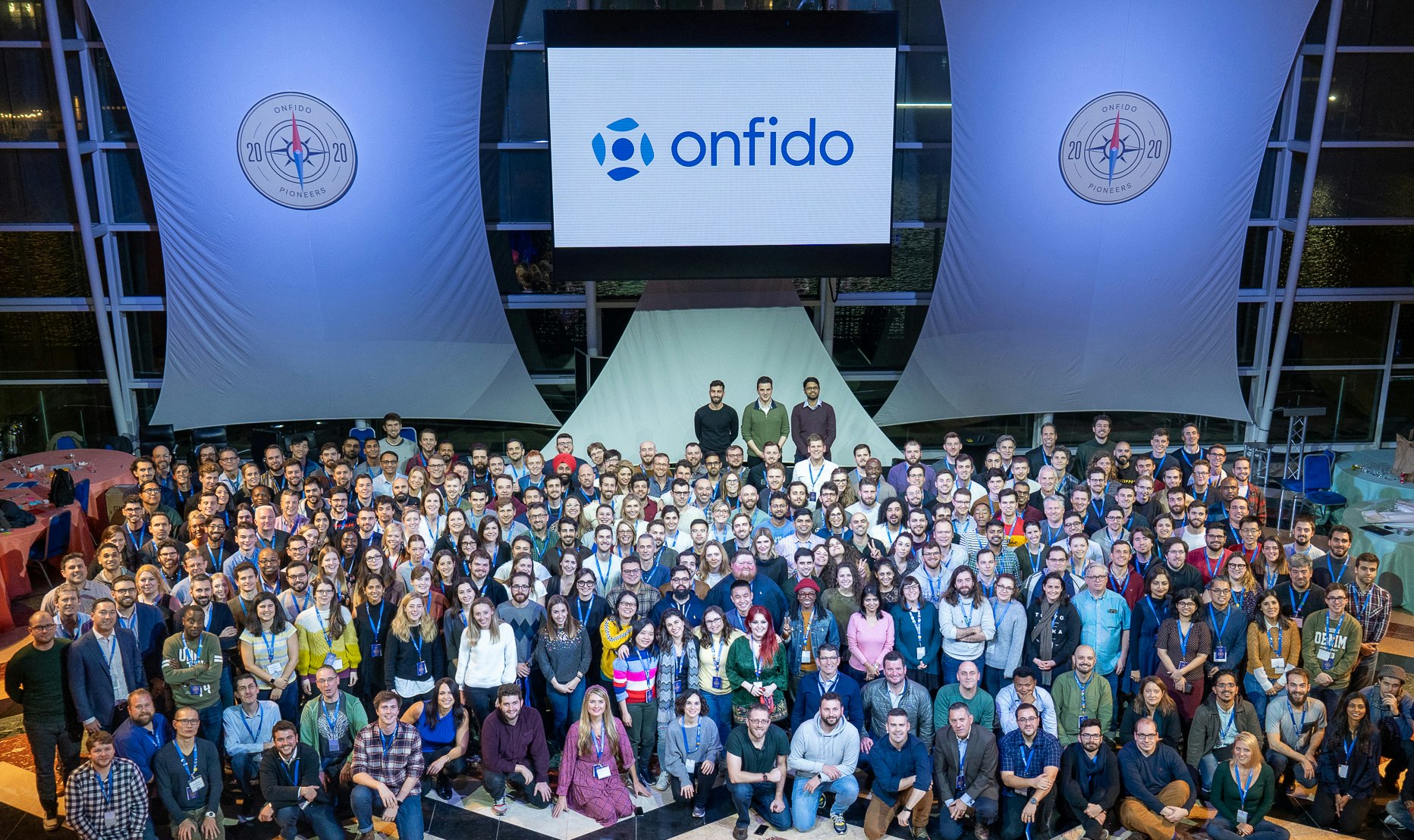 A group shot of the Onfido team in a conference room