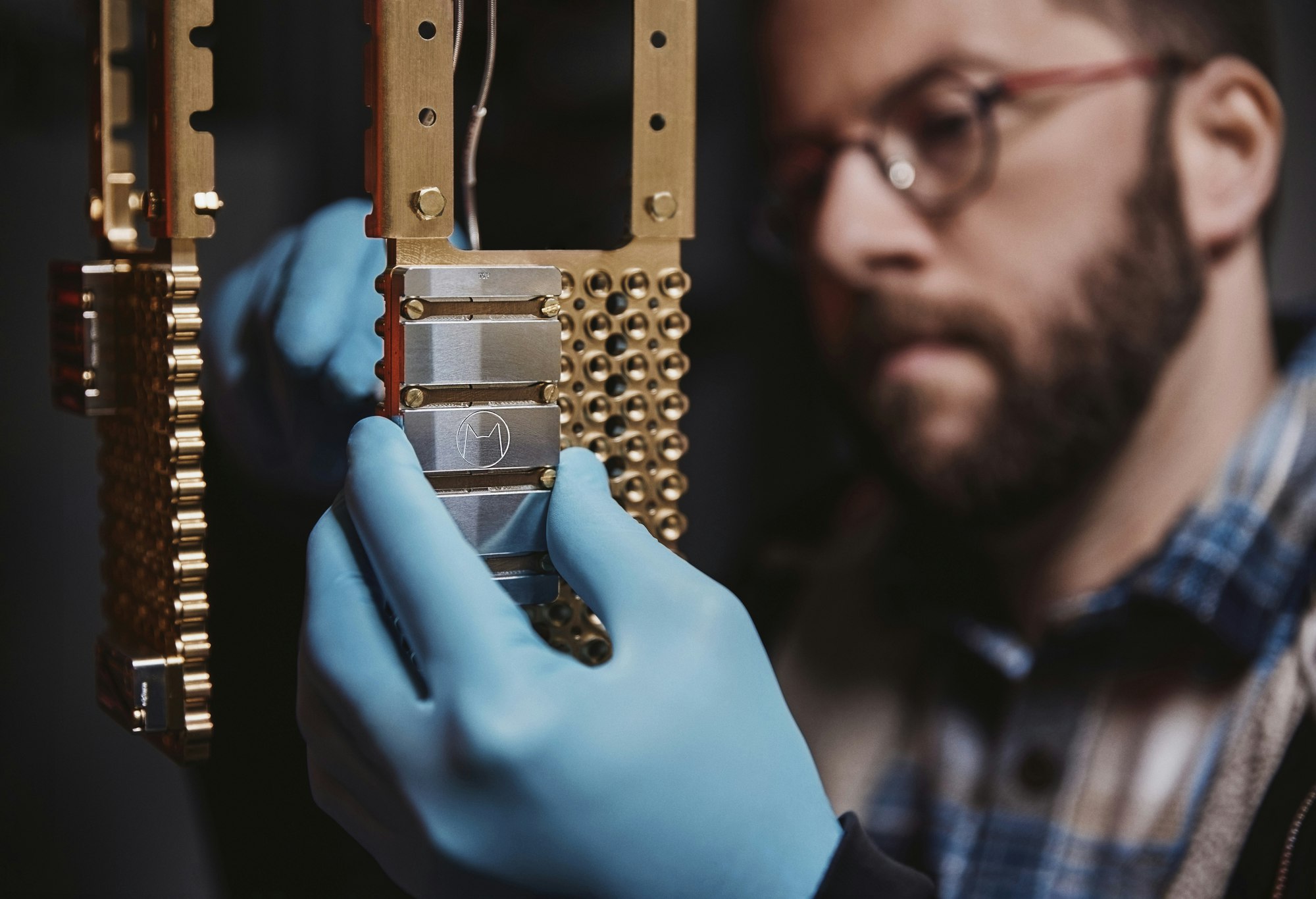 A picture of a man manipulating Alice & Bob's quantum computer