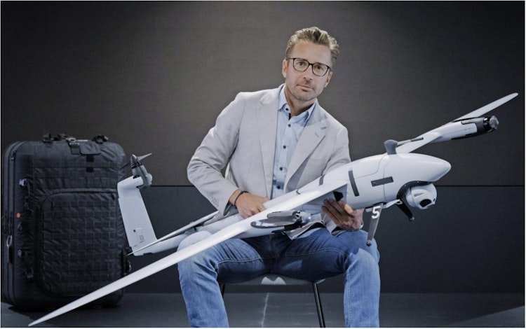 Quantum Systems and Stark founder Florian Seibel sits holding a drone.