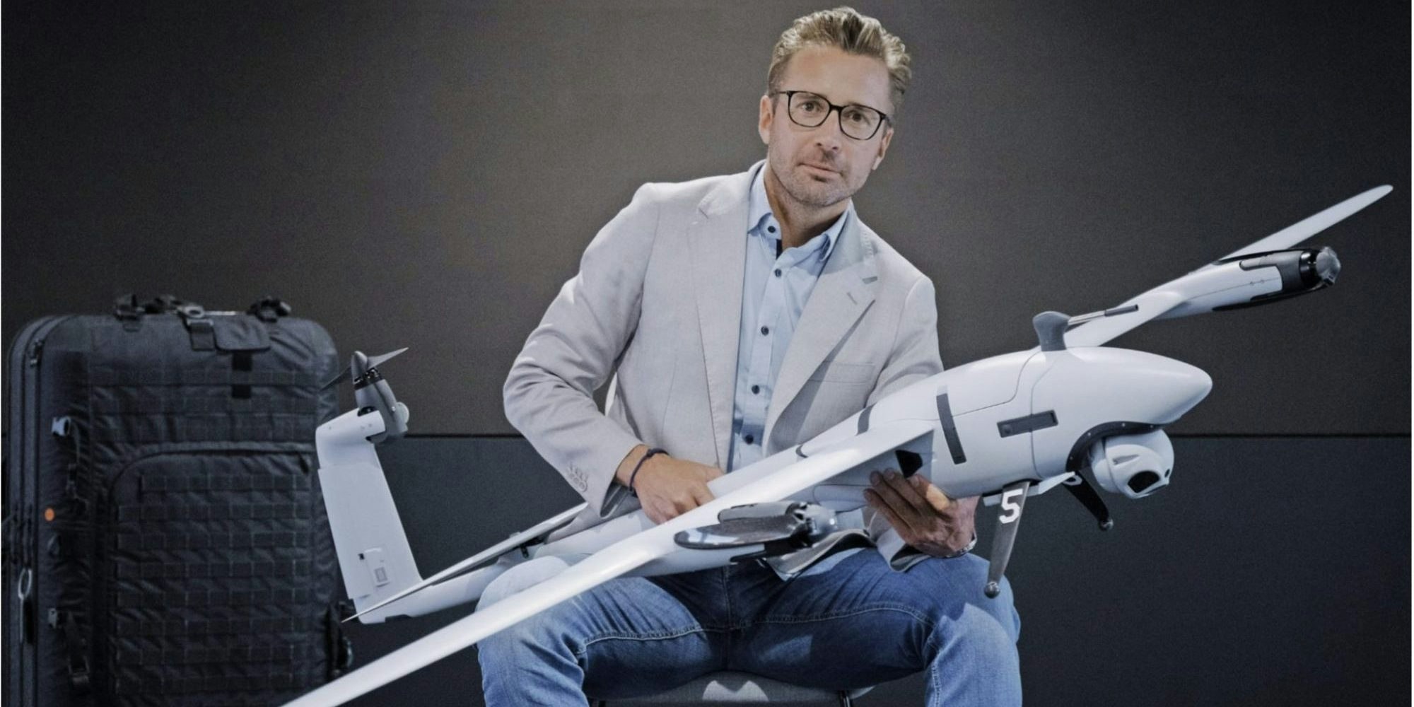 Quantum Systems and Stark founder Florian Seibel sits holding a drone.