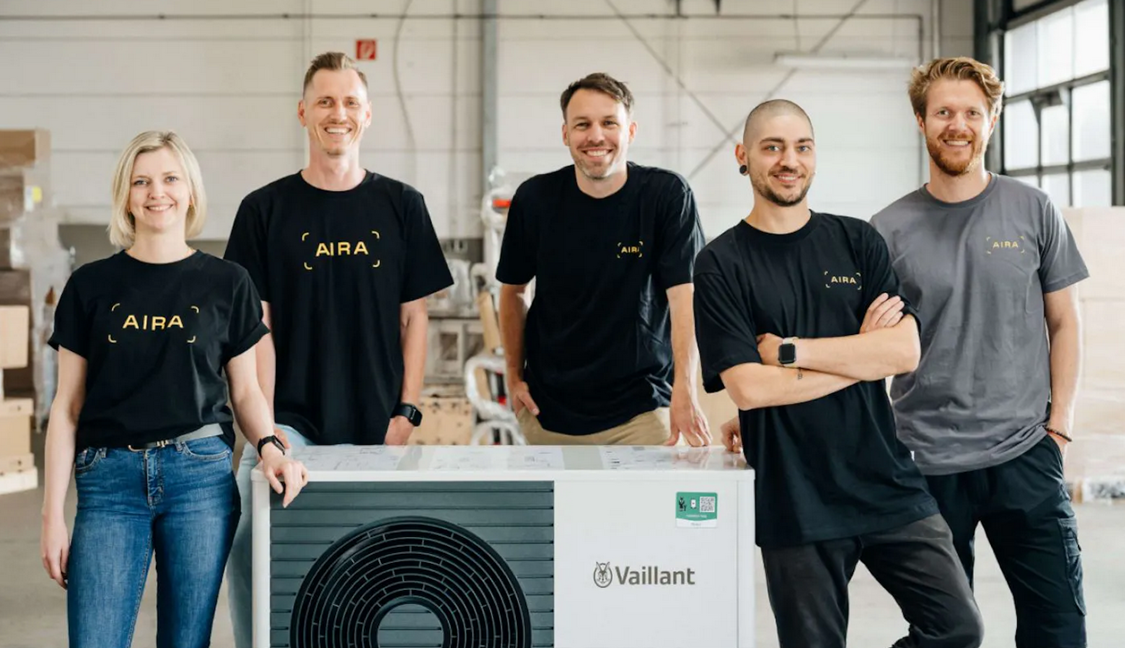 Five Aira employees standing next to a heat pump.