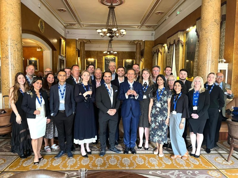 The Future Planet Capital team standing inside a decadent looking room.