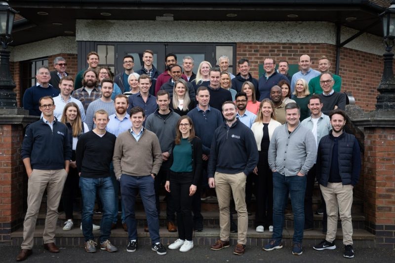 The Mercia Ventures team standing outside in front of a red brick building.