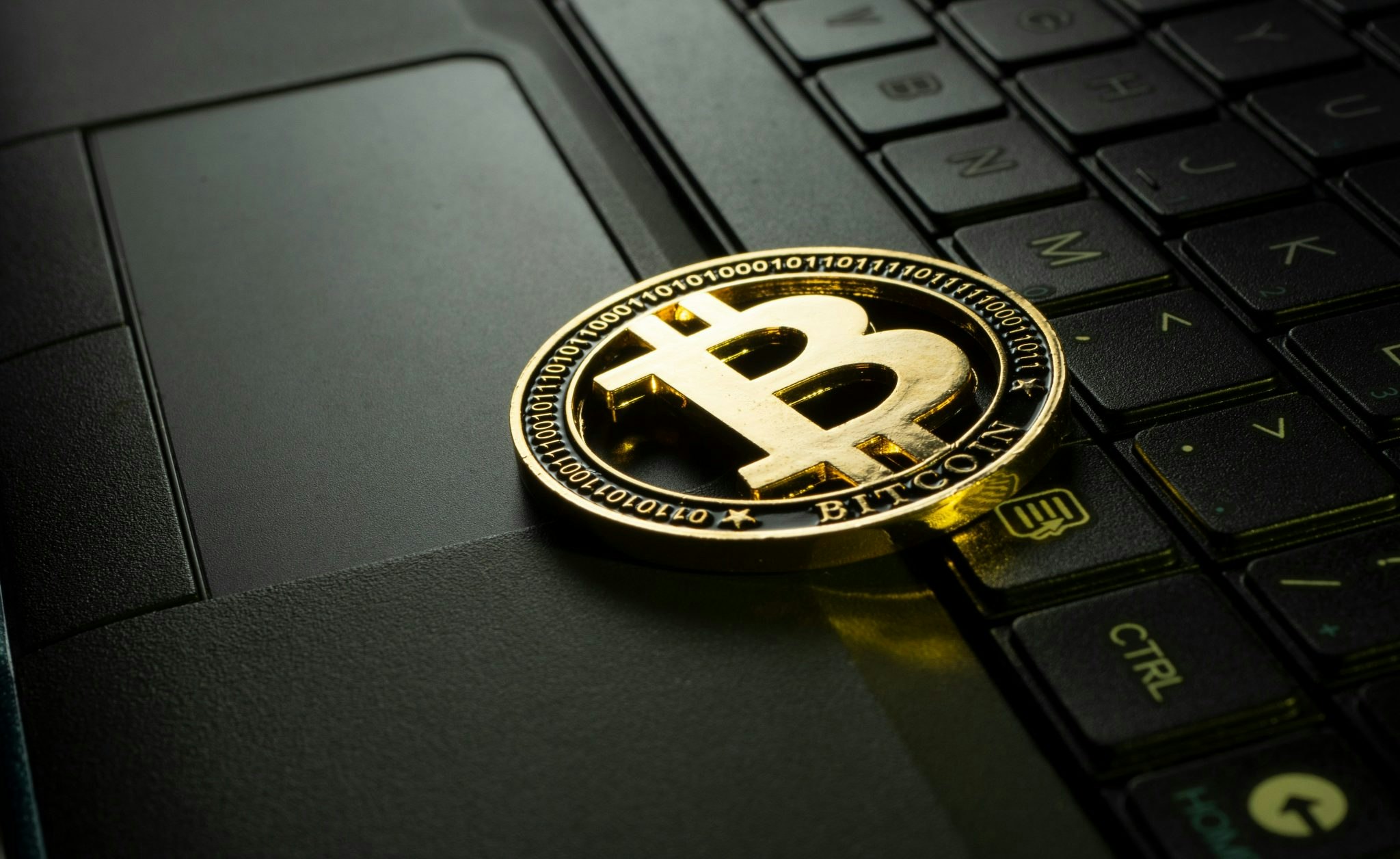 A picture of a bitcoin on a computer keyboard