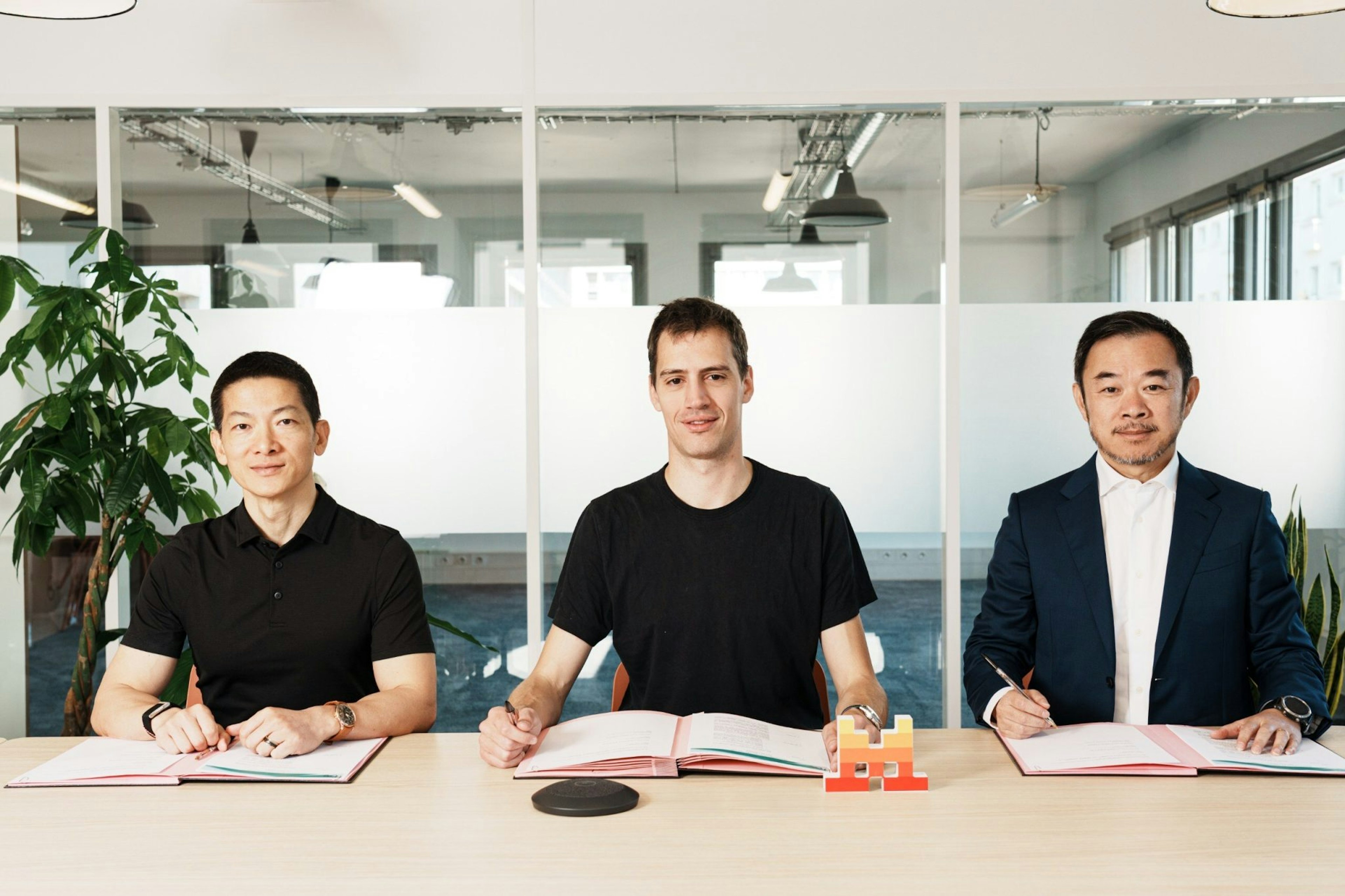 A picture of Peng Xiao, CEO of G42, Mistral AI cofounder Arthur Mensch, and Eric Xing, president of MBZUAI