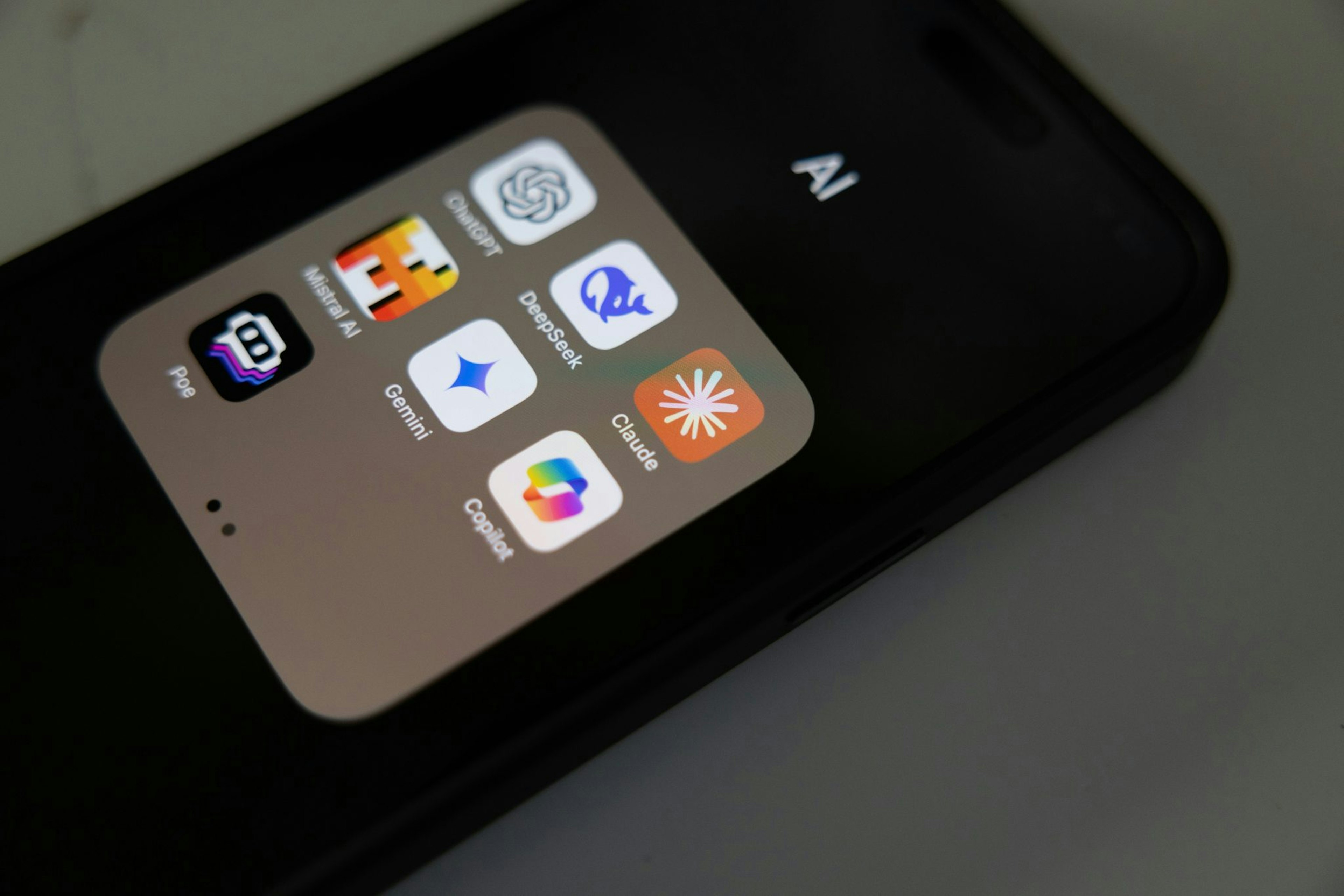 A picture of a phone screen with an AI folder including the Mistral app. Photo by Solen Feyissa on Unsplash