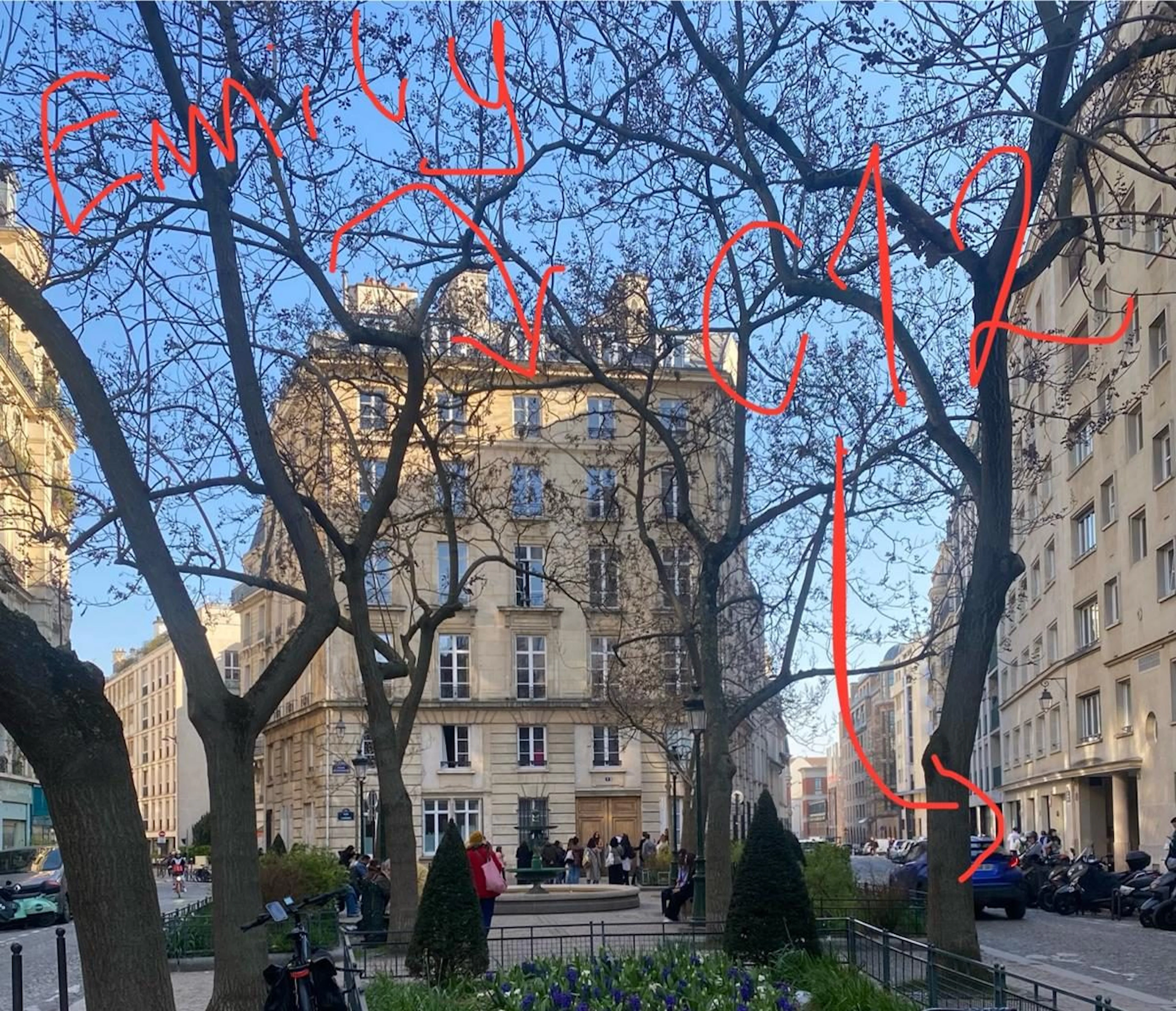 A picture of the square featuring the apartment block from Emily in Paris and the entrance to C12's office and lab